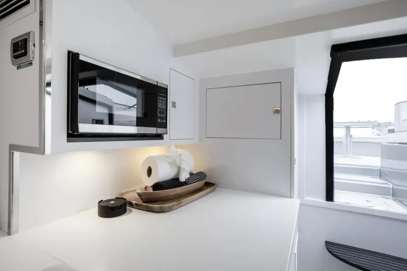 Slide: The Image of Modern kitchen interior of 2016 VanDutch CRUISER yacht with microwave and sleek design. - 6