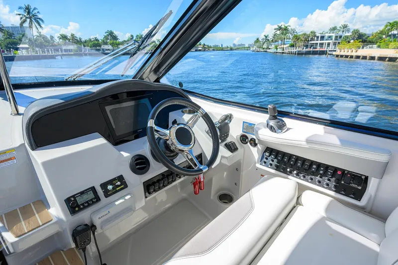 Slide: The Image of Cockpit of 2020 Regal 35 Sport Coupe with modern controls and waterfront view. - 14