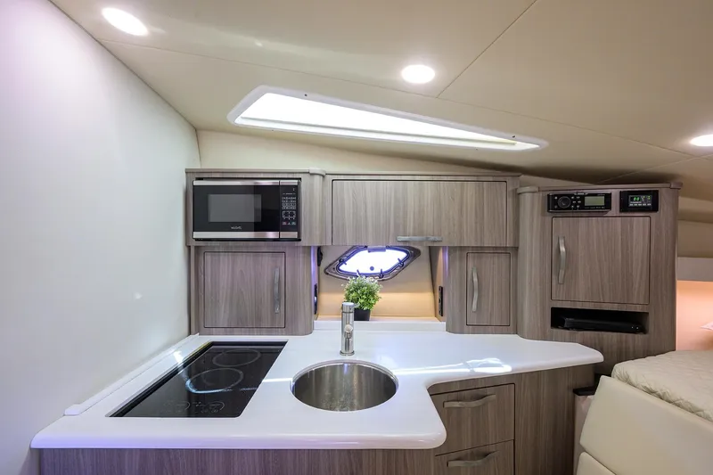 Slide: The Image of Modern kitchen interior in 2020 Regal 35 Sport Coupe yacht, featuring sleek cabinetry and appliances. - 23