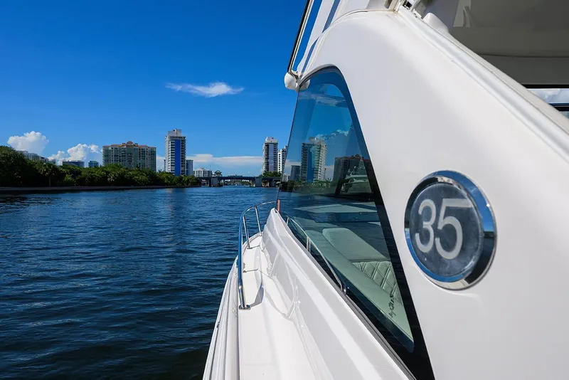 Slide: The Image of 2020 Regal 35 Sport Coupe cruising on a sunny day with city skyline. - 29