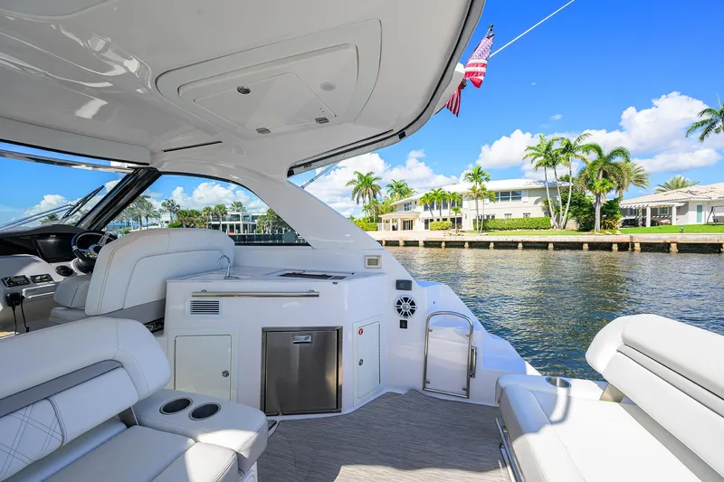 Slide: The Image of 2020 Regal 35 Sport Coupe yacht interior with waterfront view, featuring luxurious seating and amenities. - 3