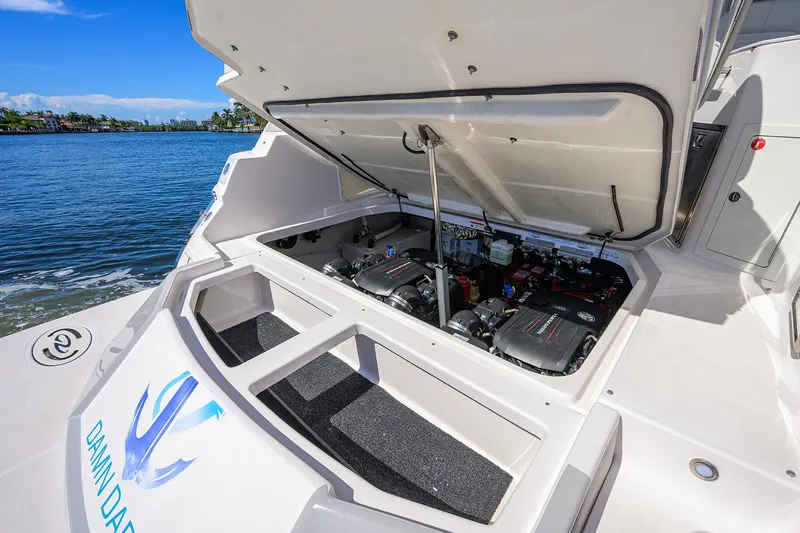 Slide: The Image of 2020 Regal 35 Sport Coupe engine compartment open, showcasing dual engines by the water. - 32