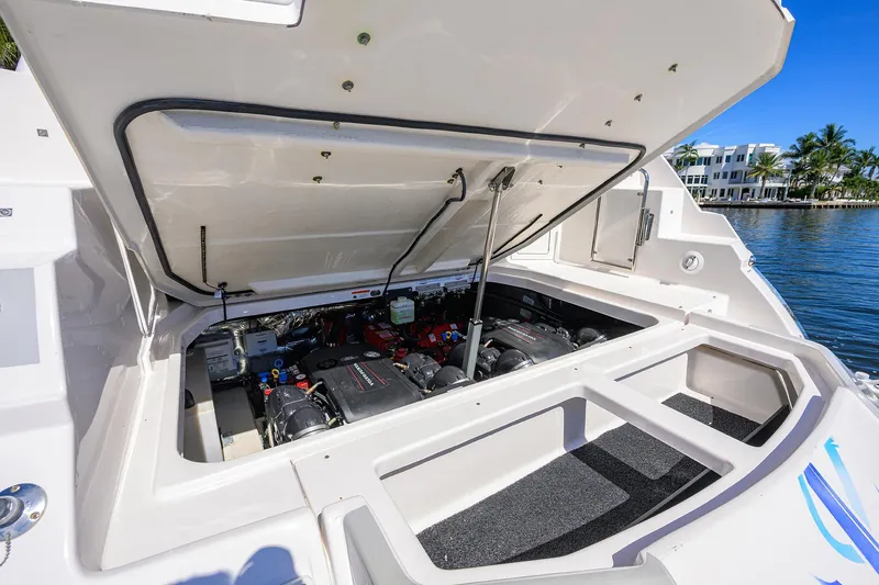 Slide: The Image of 2020 Regal 35 Sport Coupe engine compartment open, showcasing dual engines by the water. - 34