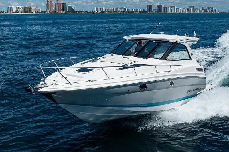 Slide: The Image of 2020 Regal 35 Sport Coupe cruising on ocean near city skyline. - 47