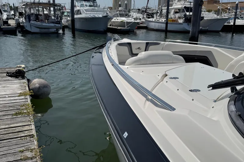 Slide: The Image of 2014 Monterey 328 Super Sport boat docked at a marina with other vessels. - 17