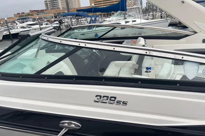 Slide: The Image of 2014 Monterey 328 Super Sport boat docked at a marina with sleek design. - 19