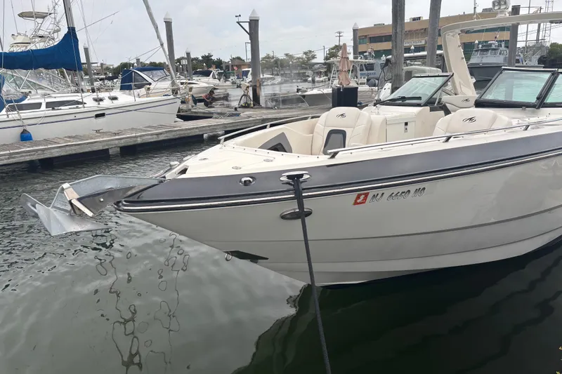 Slide: The Image of 2014 Monterey 328 Super Sport boat docked at marina, featuring sleek design and spacious seating. - 2