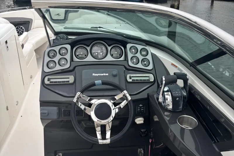 Slide: The Image of 2014 Monterey 328 Super Sport boat dashboard with steering wheel and controls. - 20
