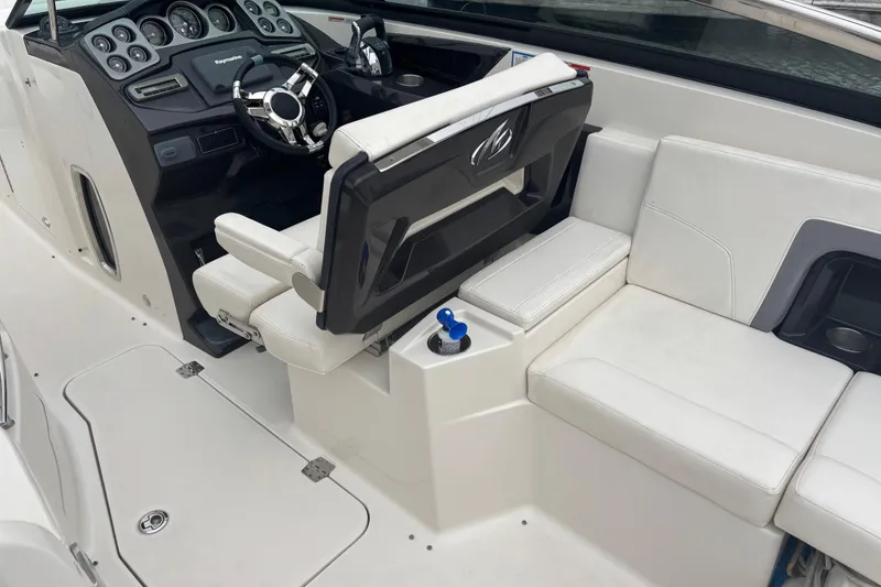 Slide: The Image of 2014 Monterey 328 Super Sport boat interior with white seating and modern dashboard. - 21