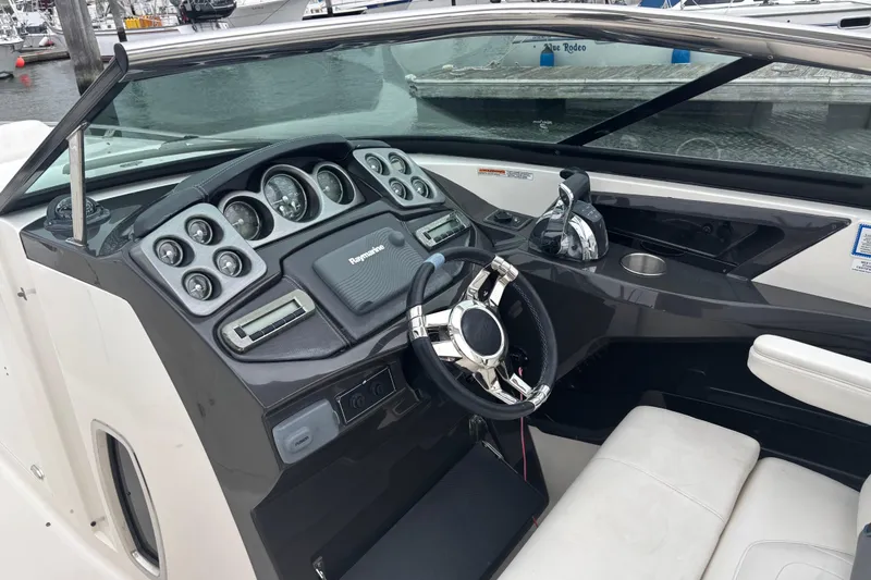 Slide: The Image of Cockpit of 2014 Monterey 328 Super Sport boat with steering wheel and control panel. - 23
