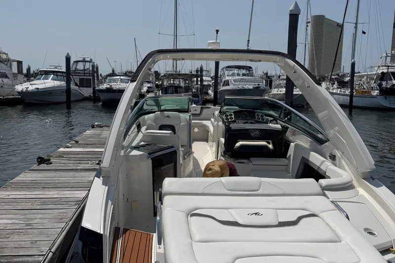 Slide: The Image of 2014 Monterey 328 Super Sport boat docked at a marina with other vessels. - 4