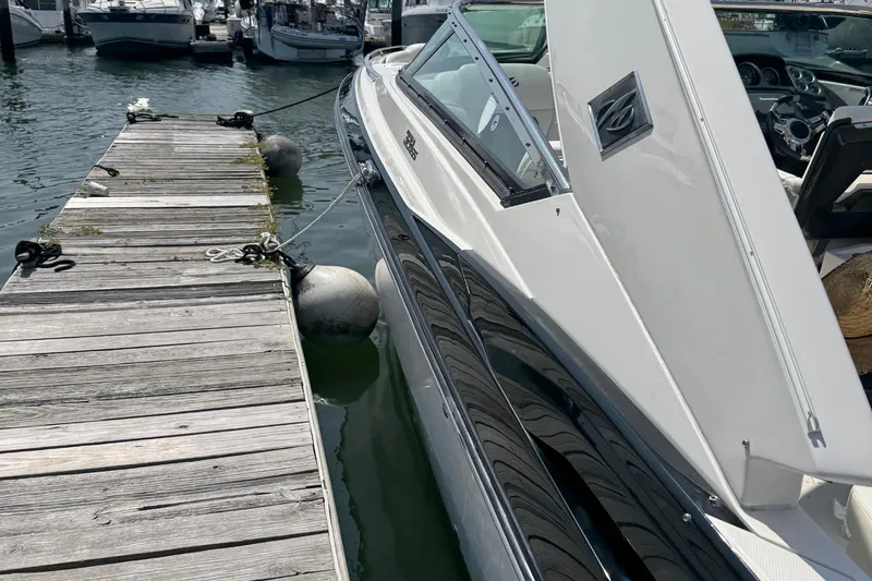 Slide: The Image of 2014 Monterey 328 Super Sport boat docked at a marina. - 5