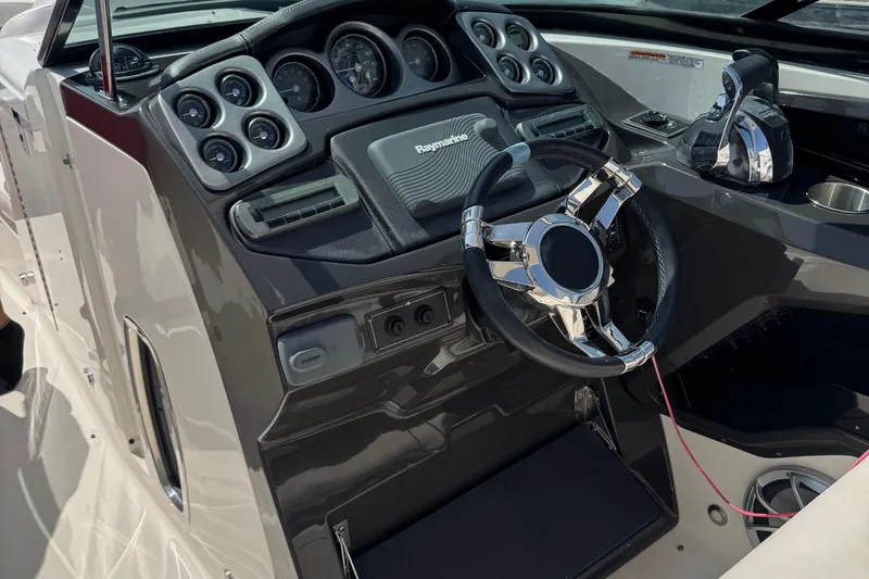 Slide: The Image of 2014 Monterey 328 Super Sport boat dashboard with steering wheel and control panel. - 6