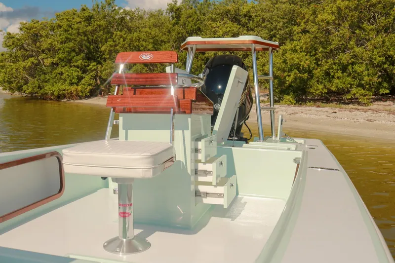 Slide: The Image of 2026 Willy Roberts 20 Bonefish boat docked near lush shoreline. - 10