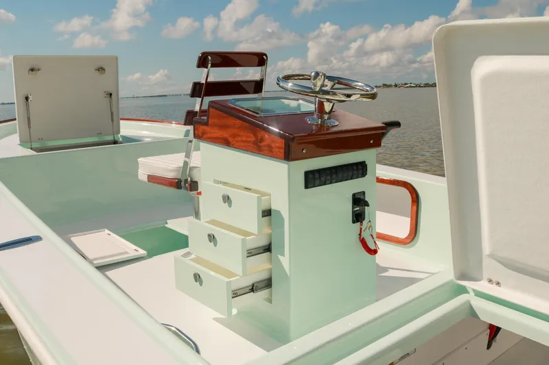 Slide: The Image of 2026 Willy Roberts 20 Bonefish boat interior with steering console and storage drawers. - 11