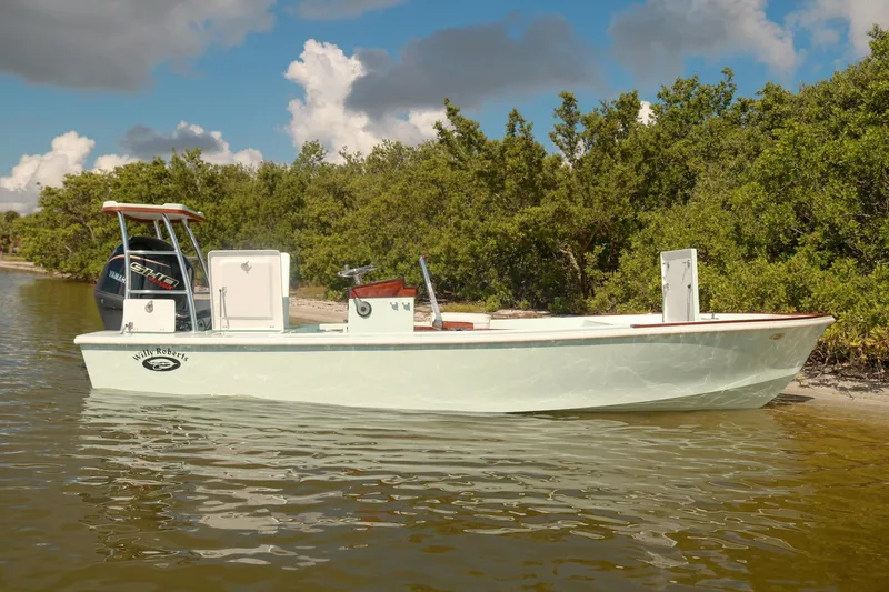 Slide: The Image of 2026 Willy Roberts 20 Bonefish boat on calm water near lush greenery. - 12