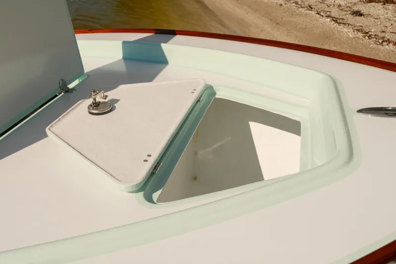 Slide: The Image of 2026 Willy Roberts 20 Bonefish boat hatch open, showcasing storage compartment. - 13