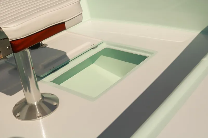 Slide: The Image of 2026 Willy Roberts 20 Bonefish boat interior with white seat and storage compartment. - 15