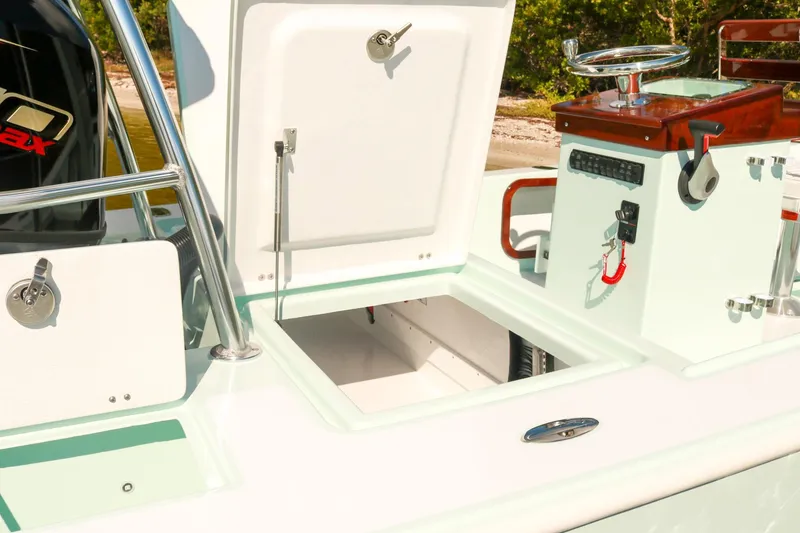 Slide: The Image of 2026 Willy Roberts 20 Bonefish boat interior with open storage compartments and control panel. - 16