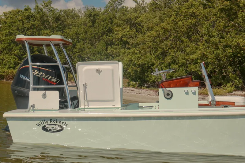 Slide: The Image of 2026 Willy Roberts 20 Bonefish boat with Yamaha engine near lush shoreline. - 20