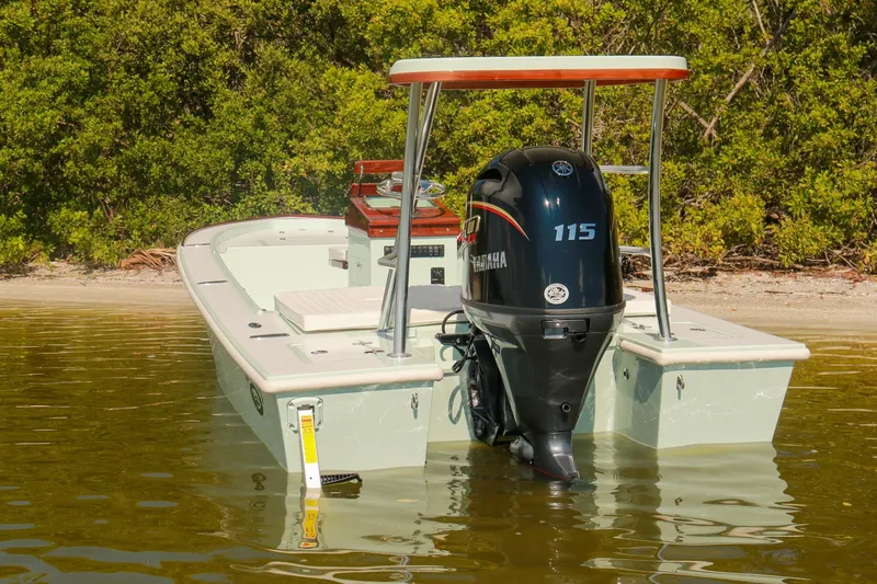 Slide: The Image of 2026 Willy Roberts 20 Bonefish boat with Yamaha 115 engine, docked near shoreline. - 9