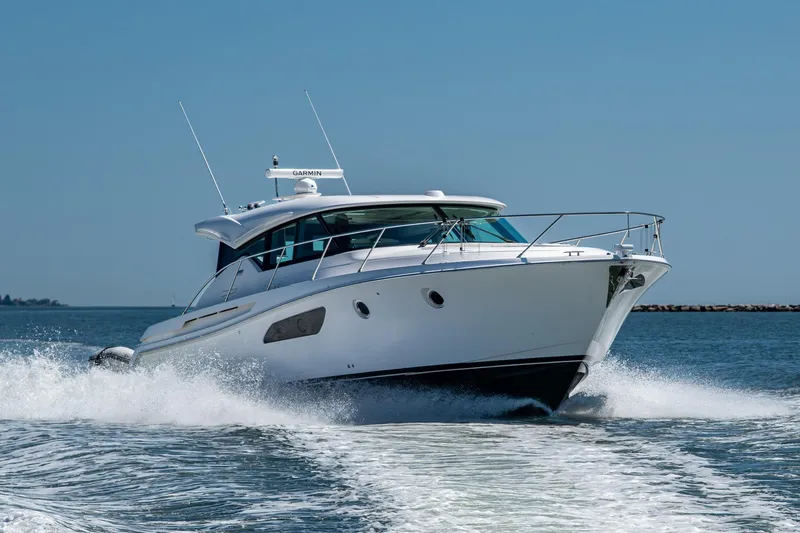 Slide: The Image of 2020 Tiara Yachts C44 Coupe cruising on open water, showcasing sleek design and performance. - 0