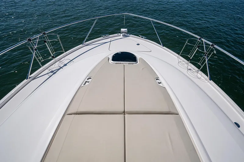 Slide: The Image of 2020 Tiara Yachts C44 Coupe bow with sunpad, surrounded by water. - 10
