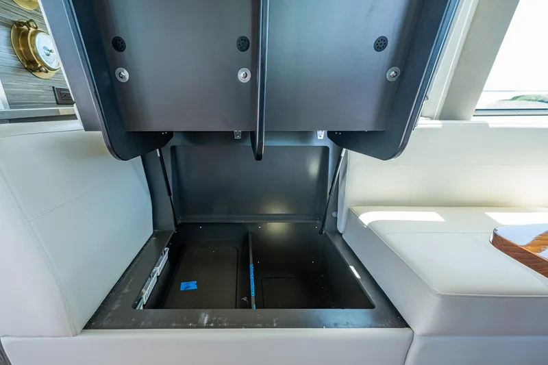 Slide: The Image of 2020 Tiara Yachts C44 Coupe interior storage compartment with open hatch. - 100