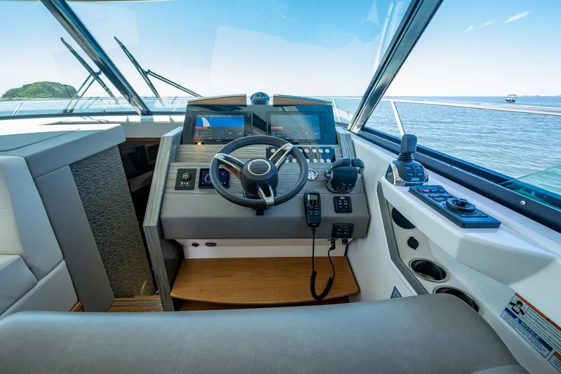Slide: The Image of 2020 Tiara Yachts C44 Coupe helm with modern controls and ocean view. - 104