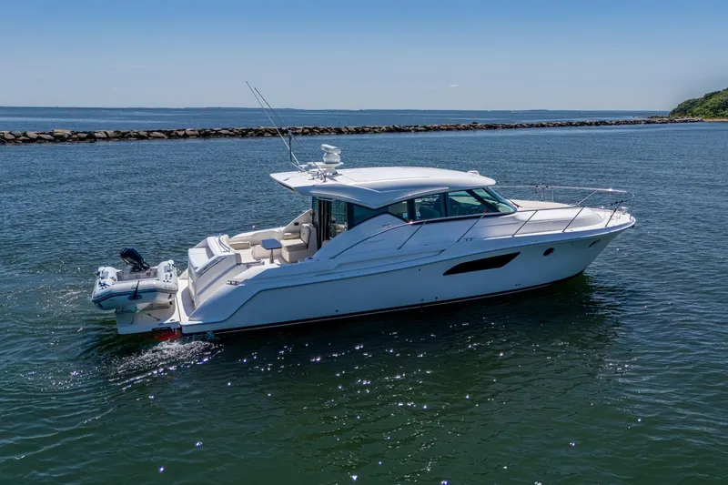 Slide: The Image of 2020 Tiara Yachts C44 Coupe cruising on calm waters under clear skies. - 15