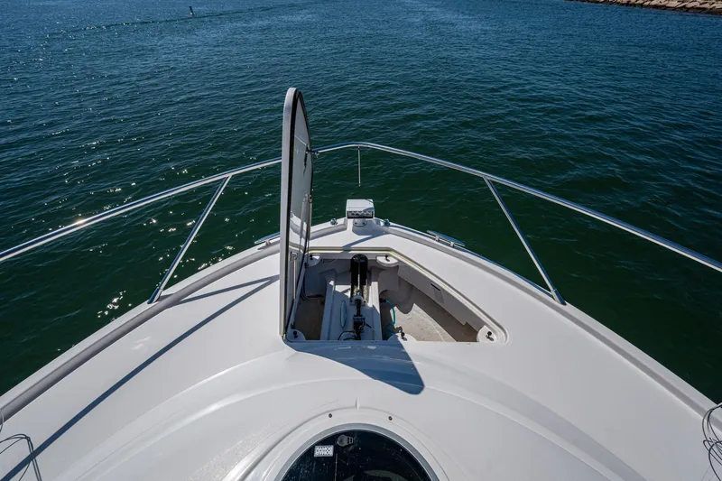 Slide: The Image of Bow view of 2020 Tiara Yachts C44 Coupe on open water. - 27