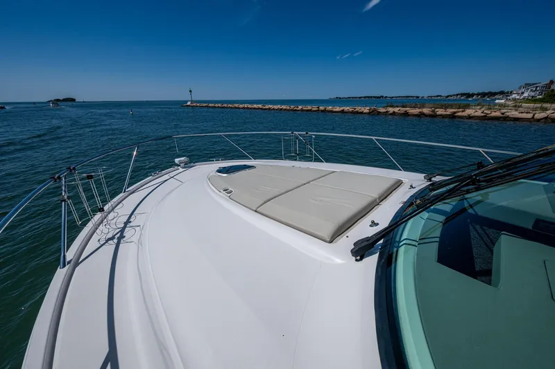 Slide: The Image of 2020 Tiara Yachts C44 Coupe cruising on a sunny day, showcasing sleek deck design. - 30