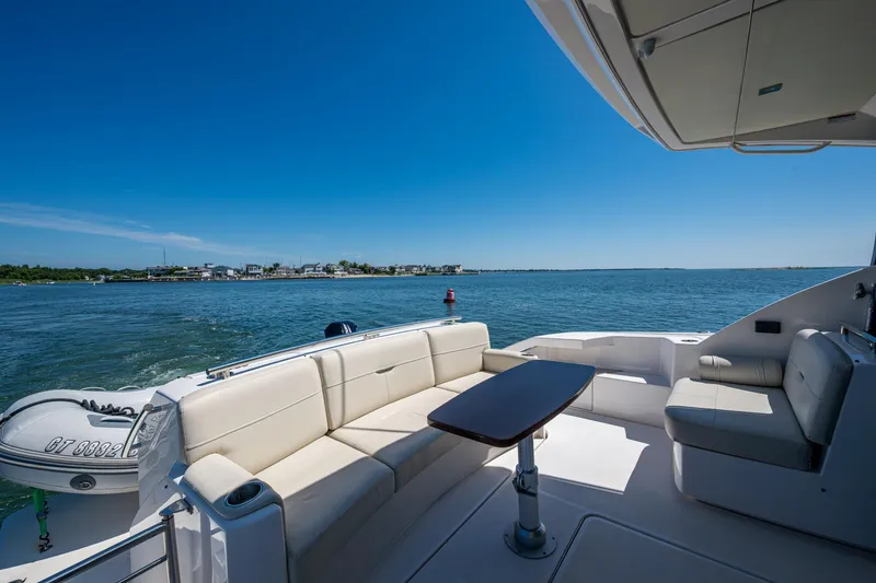 Slide: The Image of Luxurious 2020 Tiara Yachts C44 Coupe with elegant seating, cruising on serene waters. - 35