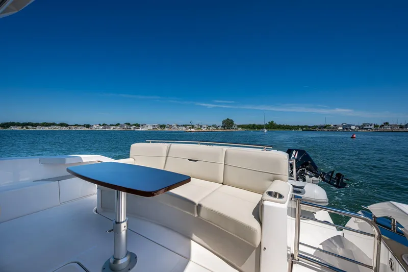 Slide: The Image of 2020 Tiara Yachts C44 Coupe, featuring elegant seating and scenic water views. - 38