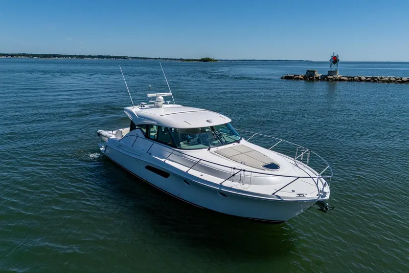 Slide: The Image of 2020 Tiara Yachts C44 Coupe cruising on calm waters under clear blue skies. - 4
