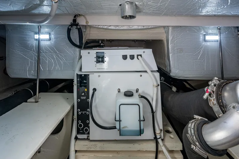 Slide: The Image of Engine room of 2020 Tiara Yachts C44 Coupe, showcasing mechanical components and insulation. - 44