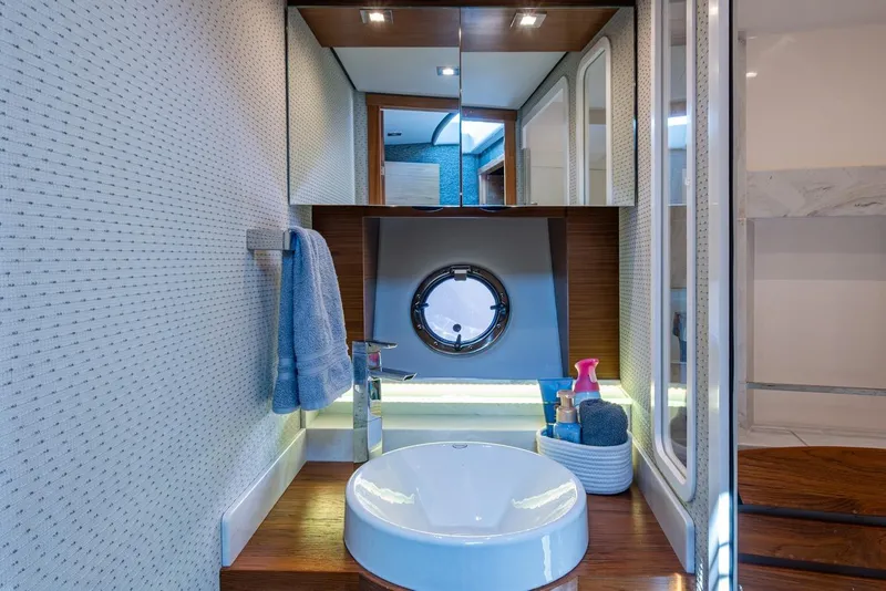 Slide: The Image of Luxurious bathroom in 2020 Tiara Yachts C44 Coupe with modern fixtures and porthole window. - 57