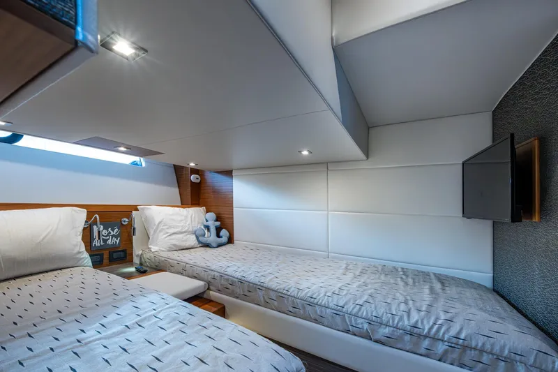 Slide: The Image of Luxurious 2020 Tiara Yachts C44 Coupe cabin with twin beds and modern decor. - 59