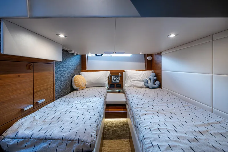 Slide: The Image of 2020 Tiara Yachts C44 Coupe cabin with twin beds and nautical decor. - 60