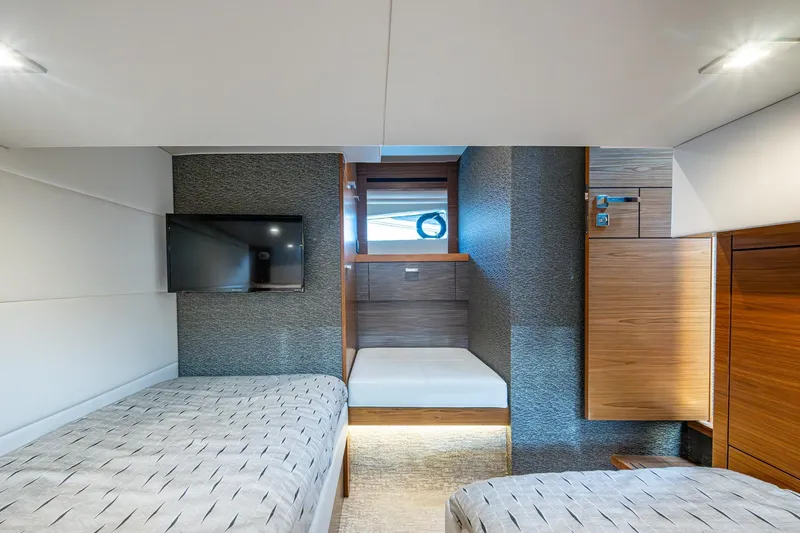 Slide: The Image of 2020 Tiara Yachts C44 Coupe interior cabin with modern design and twin beds. - 61