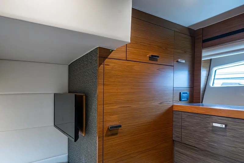 Slide: The Image of Interior of 2020 Tiara Yachts C44 Coupe, featuring sleek wood cabinetry and modern design. - 62
