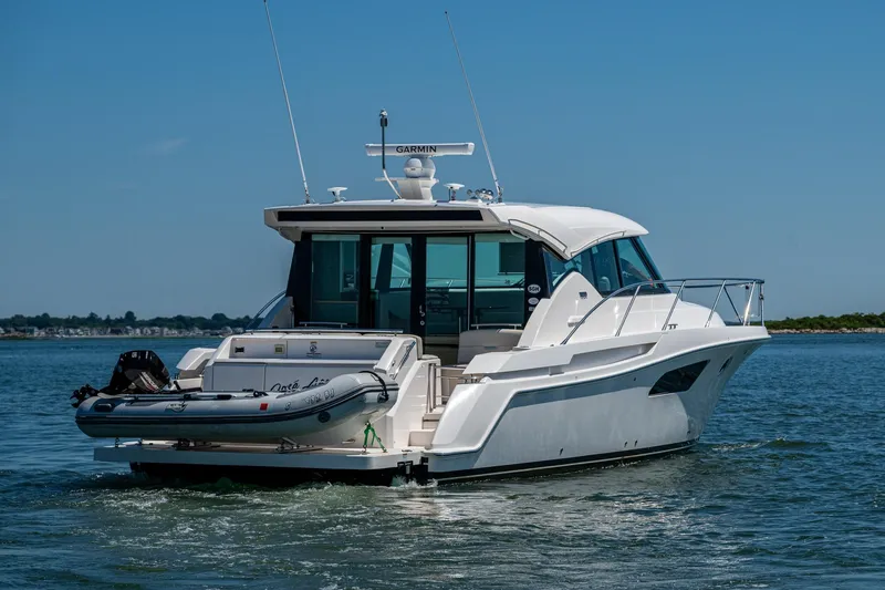 Slide: The Image of 2020 Tiara Yachts C44 Coupe cruising on open water, rear view. - 65