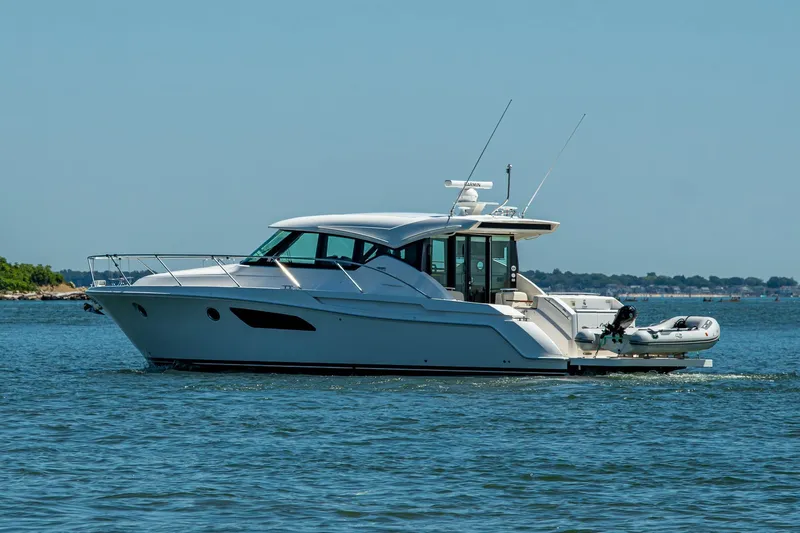 Slide: The Image of 2020 Tiara Yachts C44 Coupe cruising on open water, side view. - 68