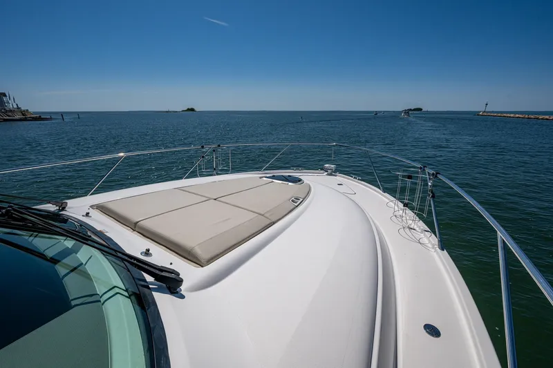 Slide: The Image of 2020 Tiara Yachts C44 Coupe cruising on open water under clear blue skies. - 7