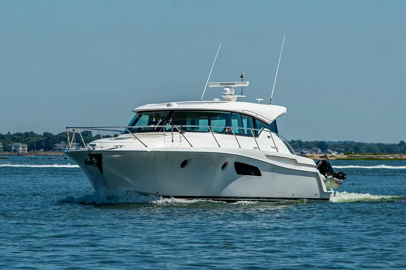 Slide: The Image of 2020 Tiara Yachts C44 Coupe cruising on open water under clear skies. - 73