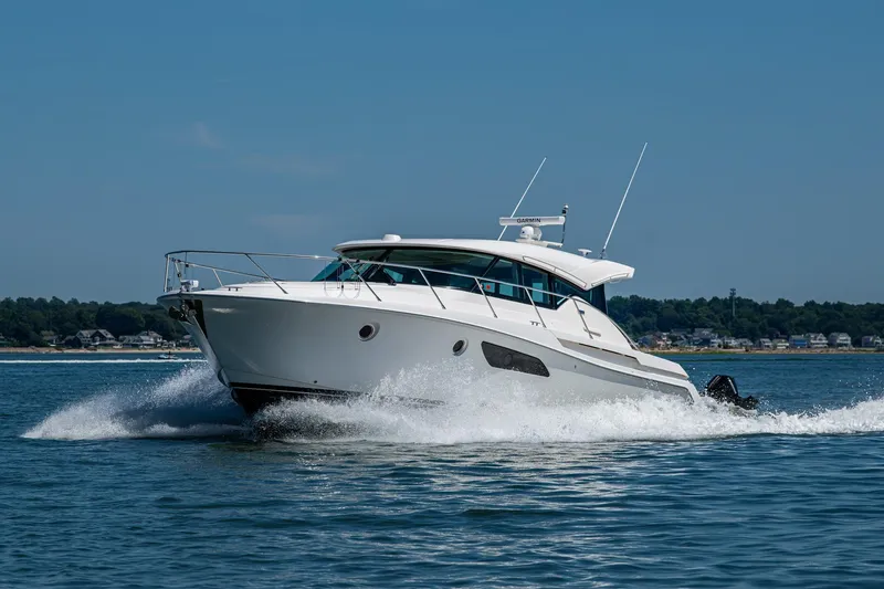 Slide: The Image of 2020 Tiara Yachts C44 Coupe cruising on open water, showcasing sleek design and performance. - 74