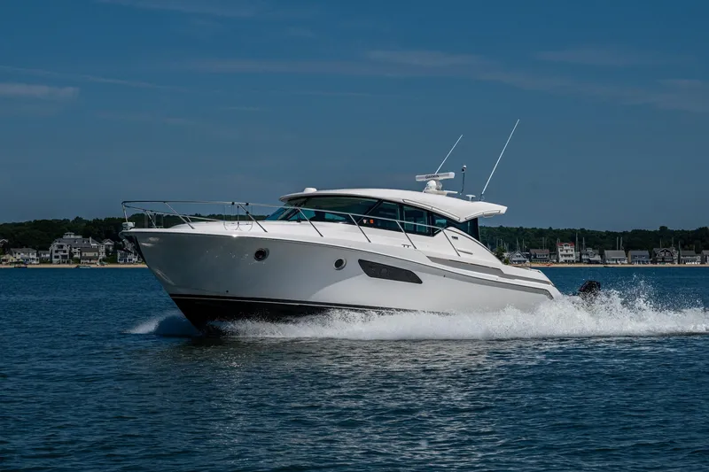 Slide: The Image of 2020 Tiara Yachts C44 Coupe cruising on open water, showcasing sleek design and performance. - 79