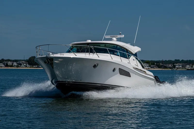 Slide: The Image of 2020 Tiara Yachts C44 Coupe cruising on open water, showcasing sleek design and performance. - 80