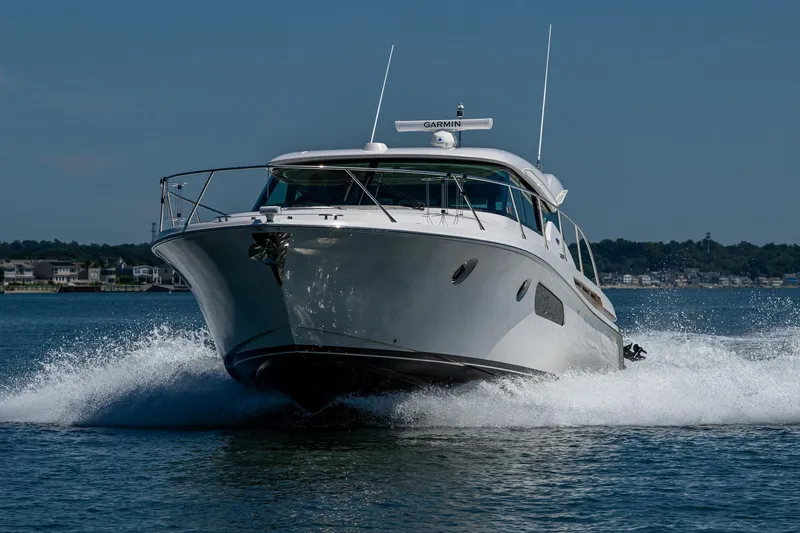 Slide: The Image of 2020 Tiara Yachts C44 Coupe cruising on water, showcasing sleek design and performance. - 81