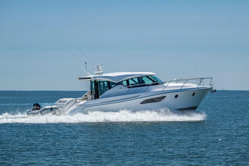 Slide: The Image of 2020 Tiara Yachts C44 Coupe cruising on open water under clear skies. - 86
